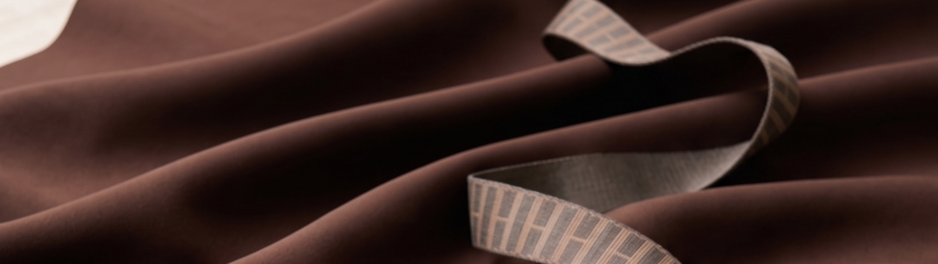 Close-up of brown fabric with a ribbon