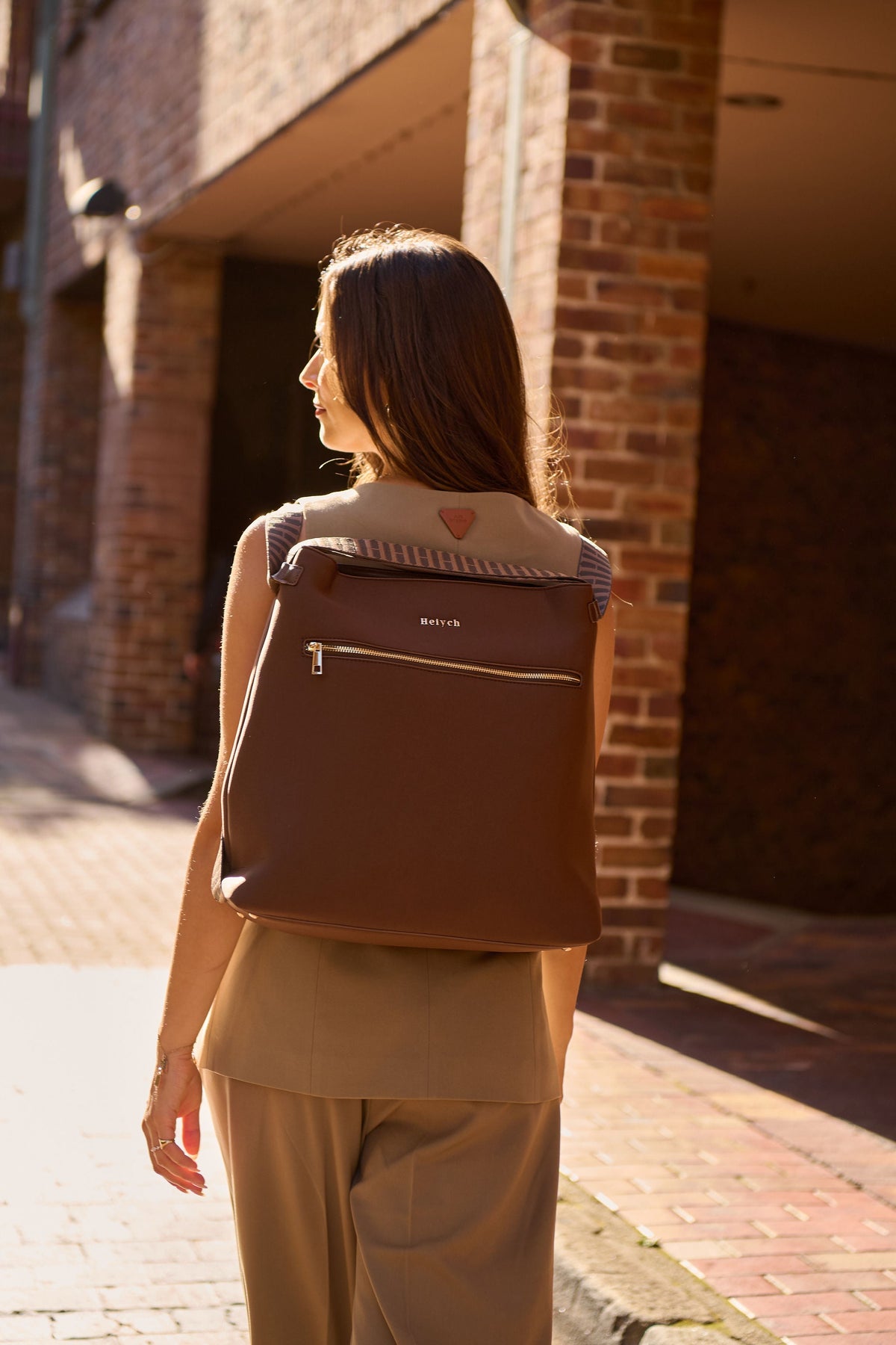 Woman wearing a Heiych convertible tote backpack in backpack mode