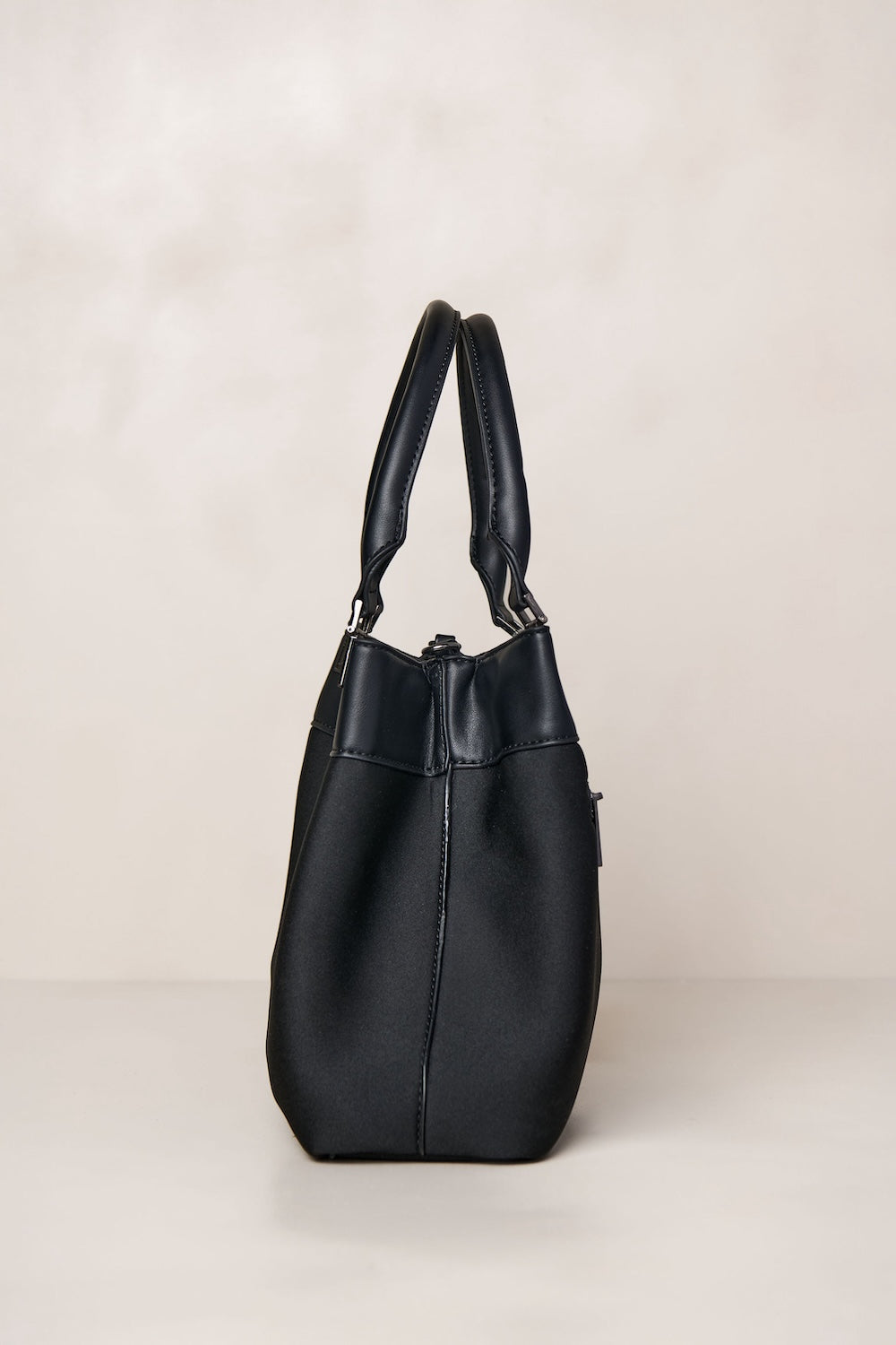 Black neoprene crossbody tote bag with handle and adjustable strap