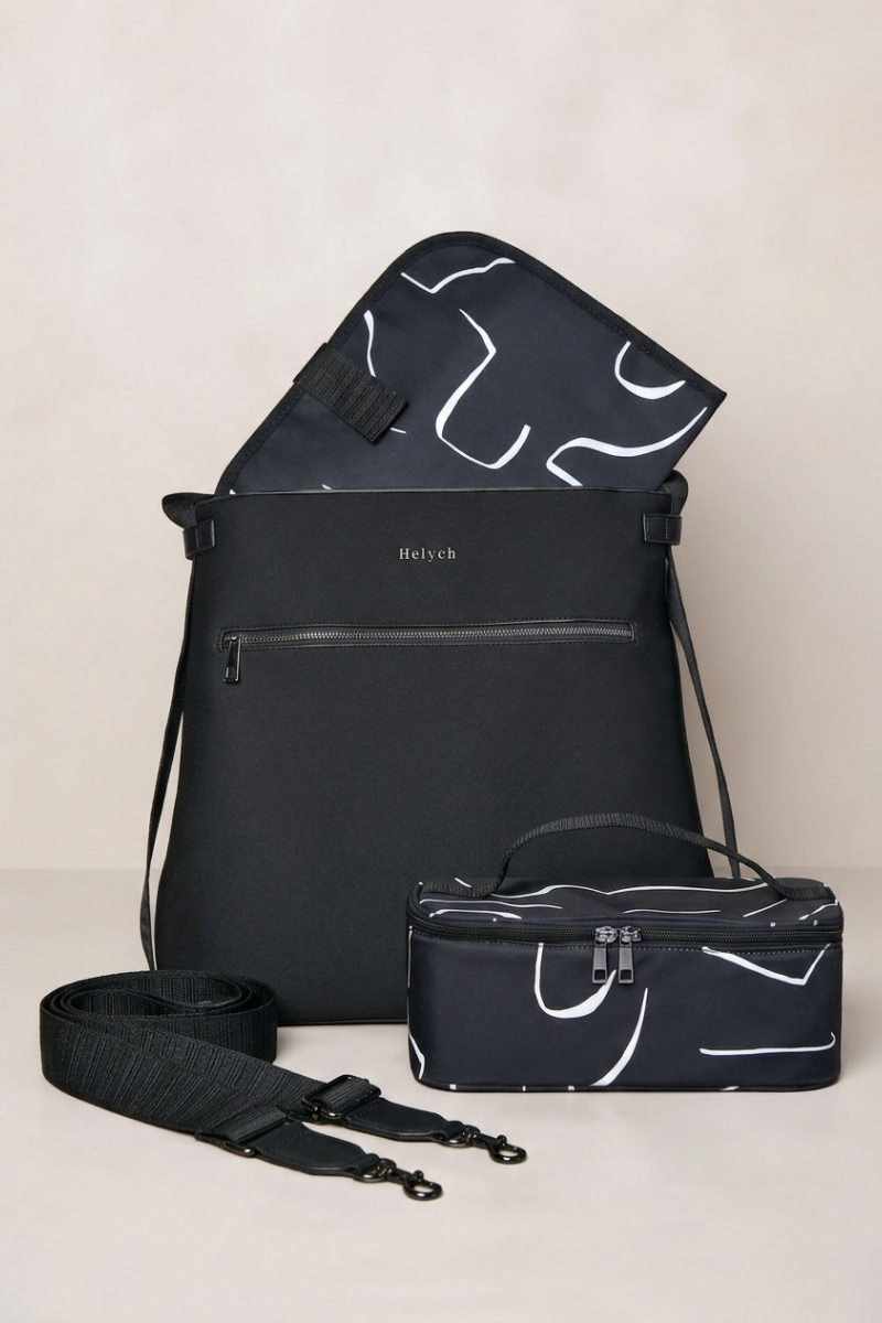 Black bag with white abstract patterns on a beige background