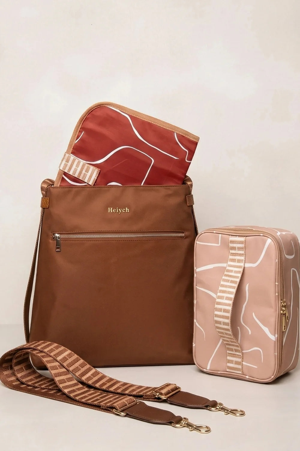 A Tan Cognac nylon tote backpack bag with a matching patterned red liner and a coordinating light pink pouch, displayed on a light beige background.