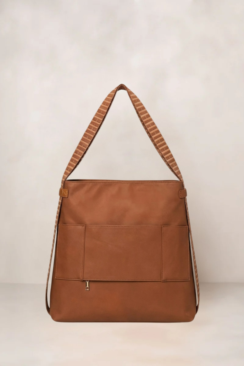 Cognac nylon handbag with a strap on a light background