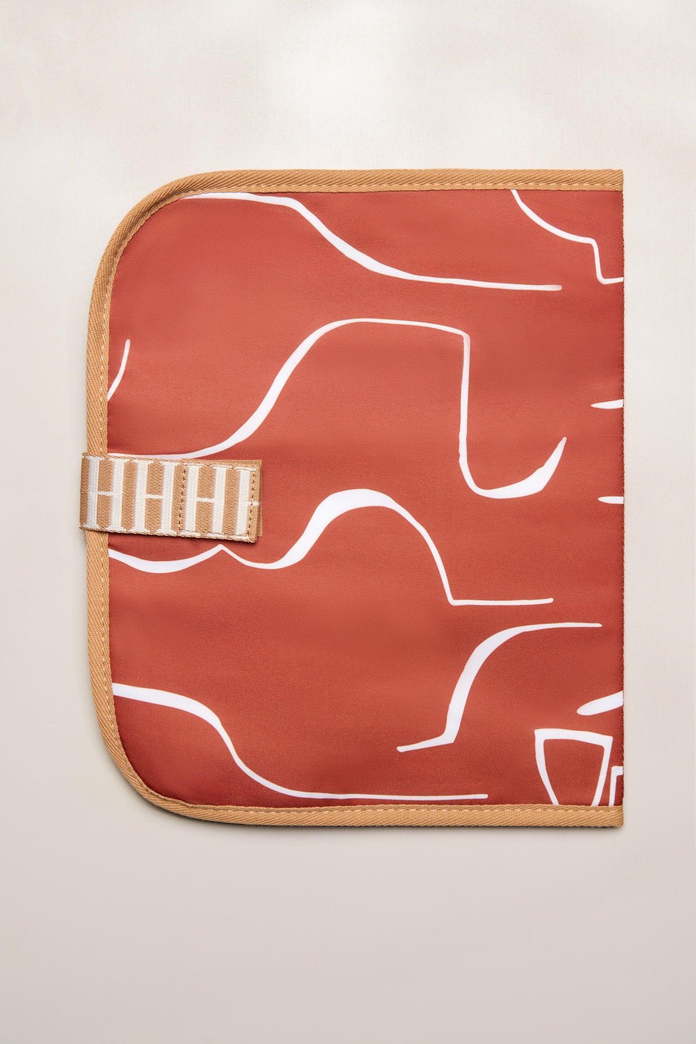 Tan Heiych change mat and laptop sleeve