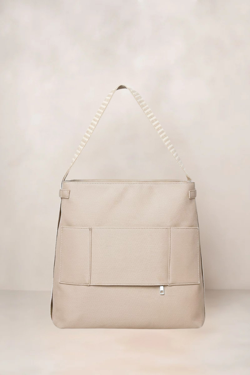 Taupe Beige tote backpack with a strap on a light beige background