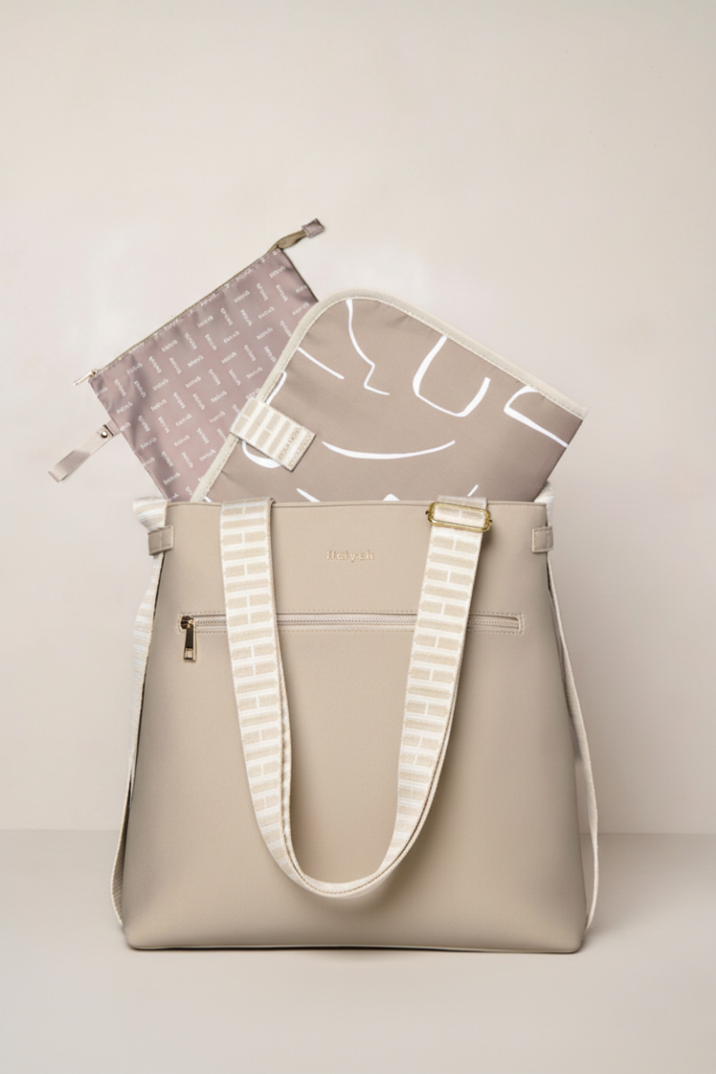 Taupe tote bag with a smaller pouch on a light beige background