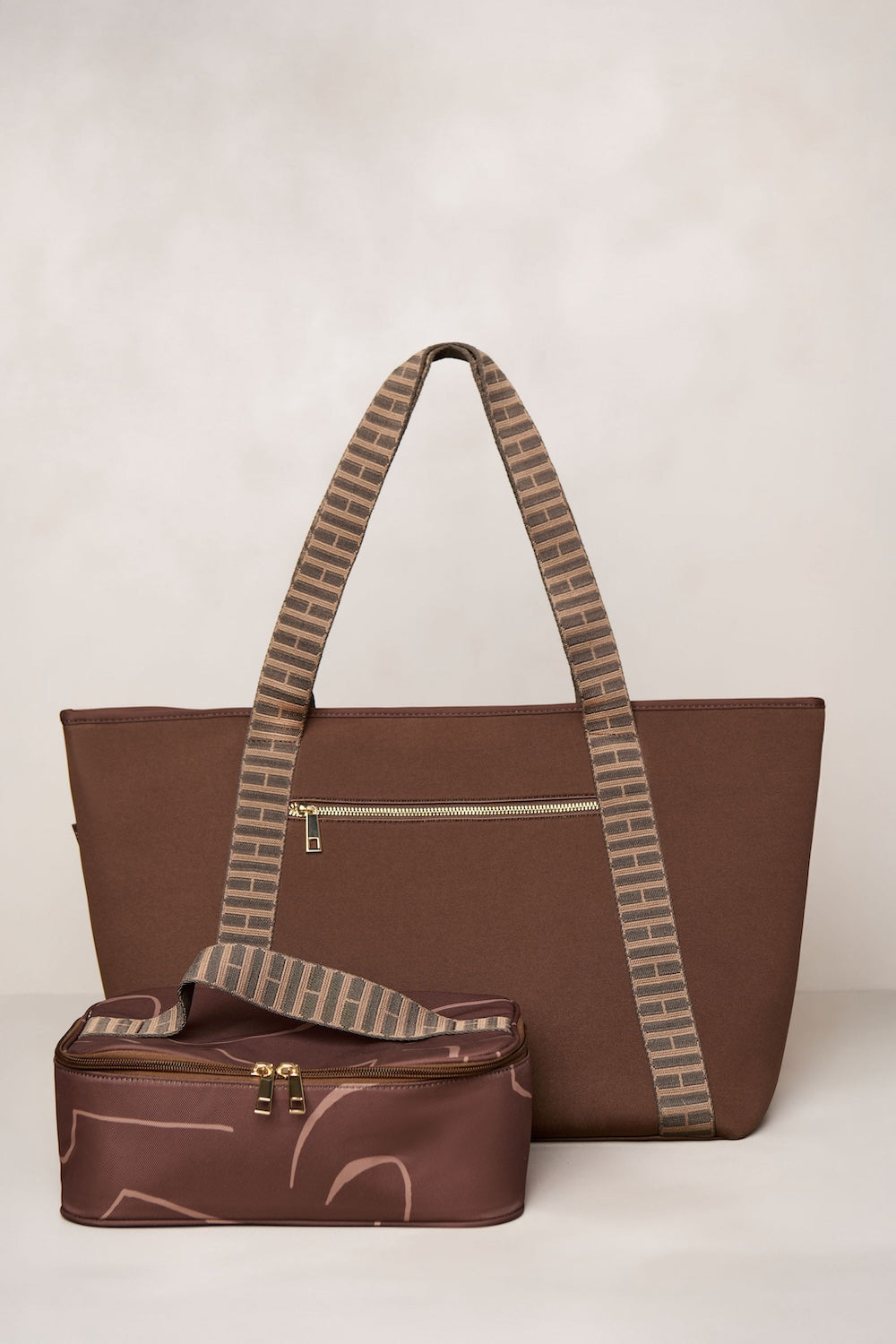 Chocolate brown tote bag with matching pouch on a light beige background