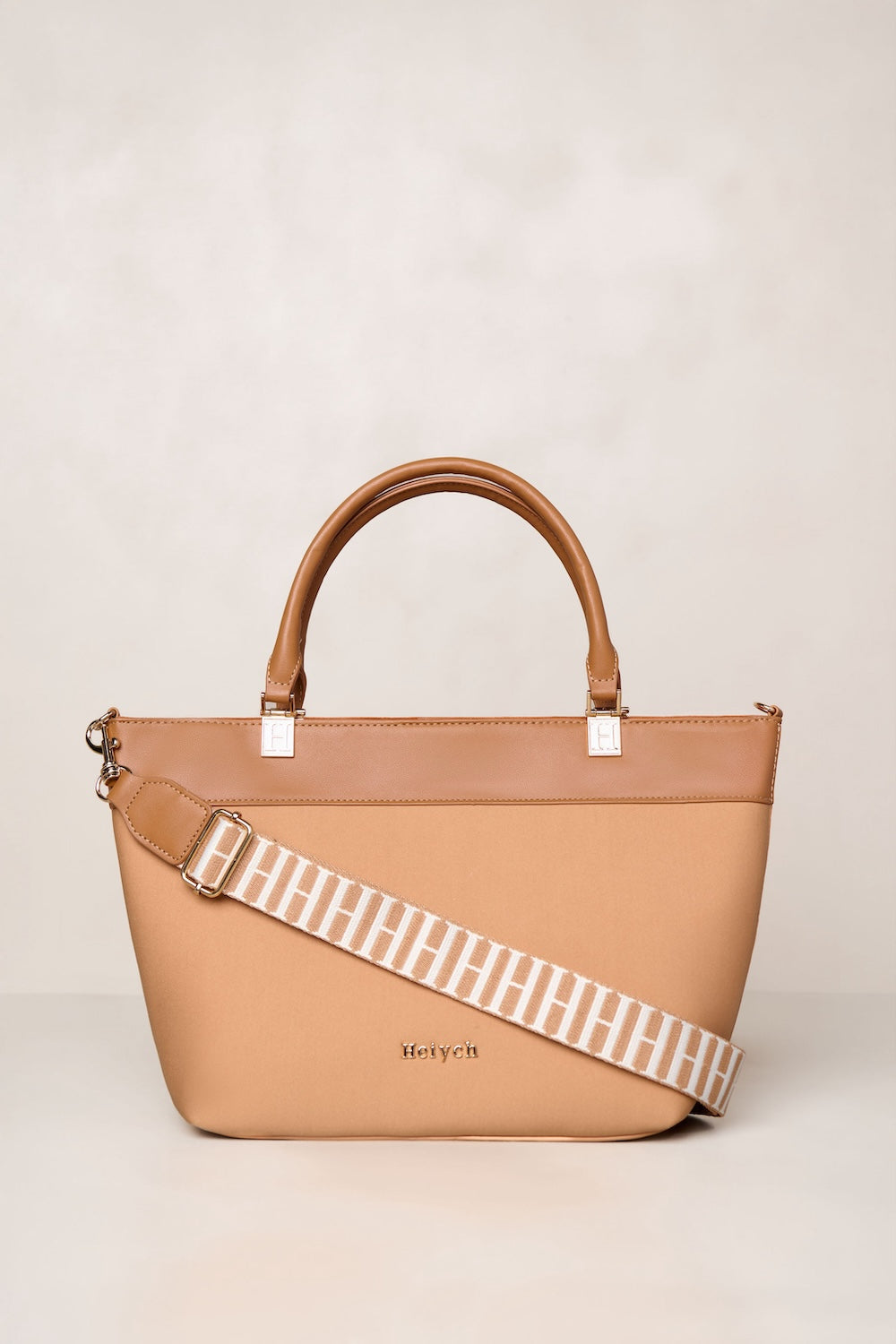 Tan neoprene crossbody tote bag with handle and adjustable strap